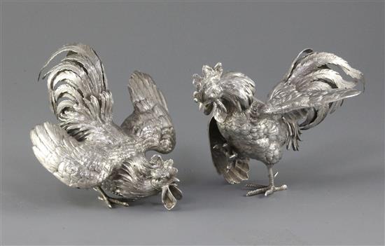 A pair of German naturalistically cast 800 standard silver models of fighting cocks, Ludwig Neresheimer, Hanau, 20 oz.